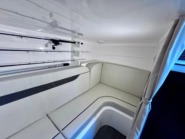 Seanior Moment Yacht Photos Pics 2022 Stamas 370 Aegean cabin interior with white seating and fishing rod storage.