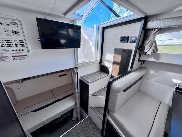 Seanior Moment Yacht Photos Pics Interior of 2022 Stamas 370 Aegean boat with seating, TV, and control panel.