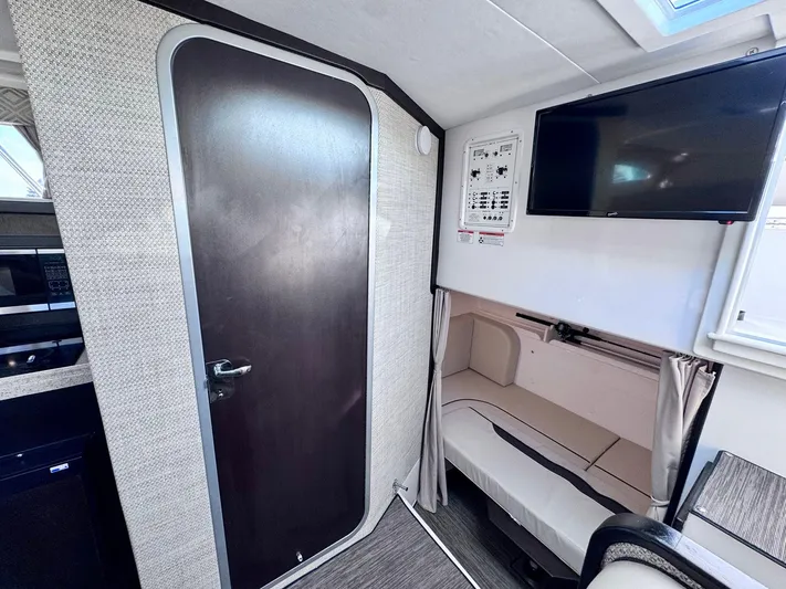 Seanior Moment Yacht Photos Pics Interior of 2022 Stamas 370 Aegean boat with TV, seating, and door.