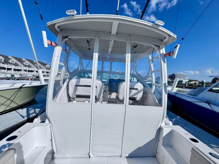 Seanior Moment Yacht Photos Pics 2022 Stamas 370 Aegean boat docked, featuring enclosed cockpit and clear skies.