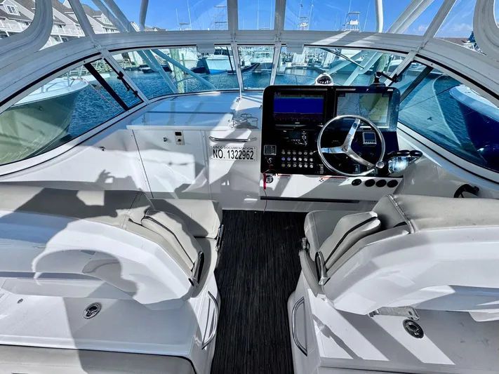 Seanior Moment Yacht Photos Pics Interior view of 2022 Stamas 370 Aegean boat cockpit with steering wheel and navigation equipment.