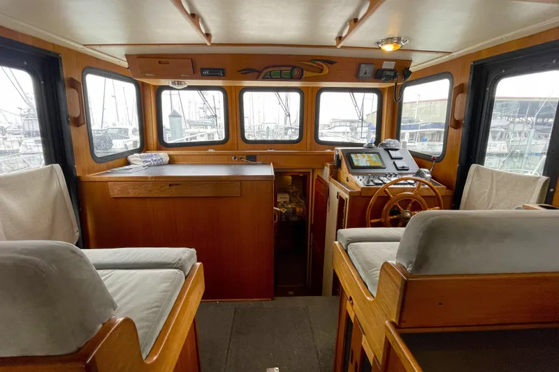 Lagnaf Yacht Photos Pics Interior of 2002 Nordic Tug 37, featuring helm station and seating area.