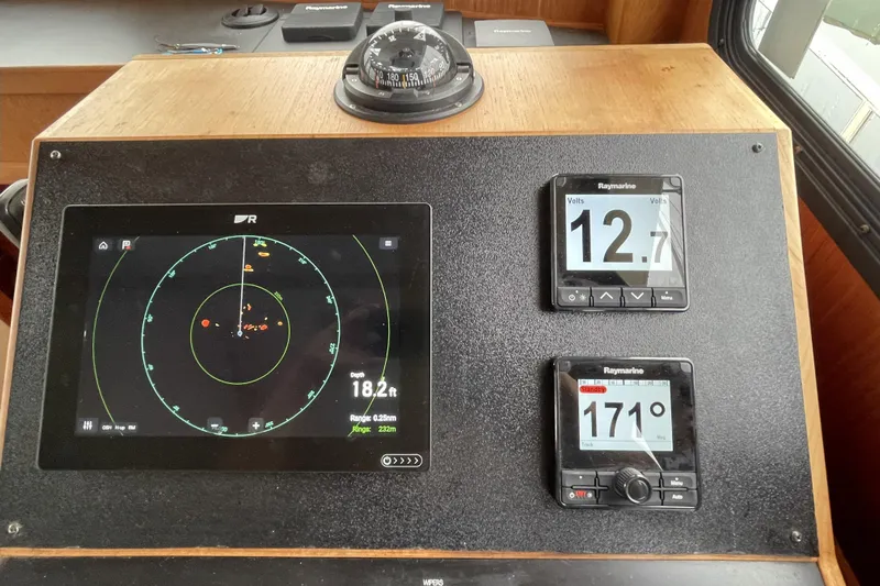 Lagnaf Yacht Photos Pics Navigation instruments on a 2002 Nordic Tug 37, featuring radar and digital displays.