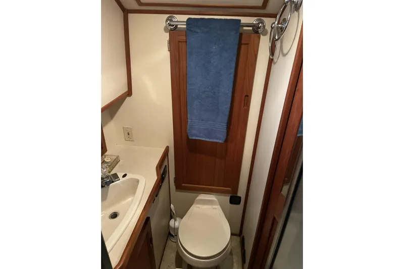 Lagnaf Yacht Photos Pics Bathroom interior of 2002 Nordic Tug 37 with sink, toilet, and towel rack.