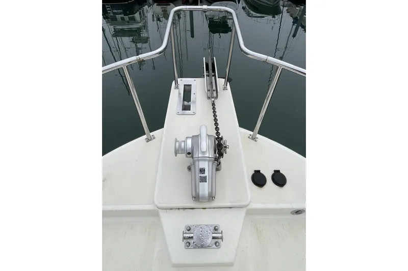 Lagnaf Yacht Photos Pics Bow view of 2002 Nordic Tug 37 with anchor winch and railing.
