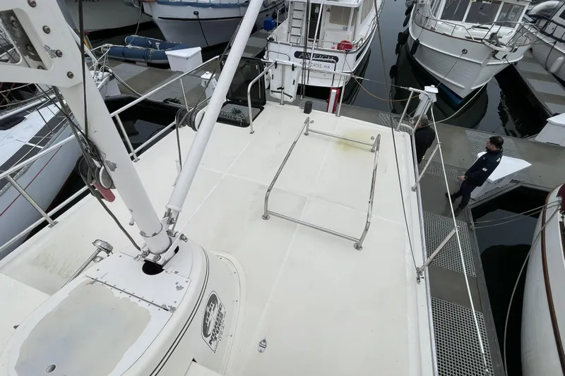 Lagnaf Yacht Photos Pics Nordic Tug 37 (2002) docked at marina, view from deck, surrounded by other boats.