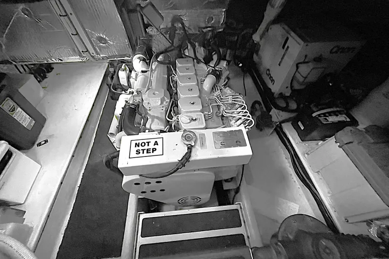 Lagnaf Yacht Photos Pics Engine room of a 2002 Nordic Tug 37 with a "Not a Step" warning sign.