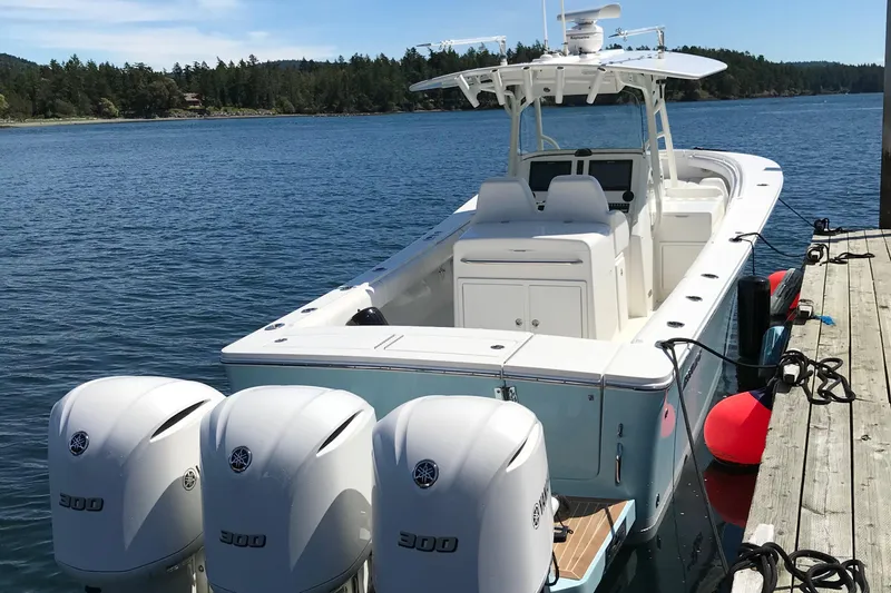 Stimulus 1 Yacht Photos Pics 2007 Regulator 34 Center Console boat docked with triple outboard engines.