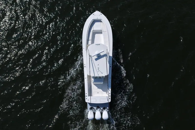 Distraction Yacht Photos Pics Aerial view of 2019 Regulator 34SS boat cruising on dark water.