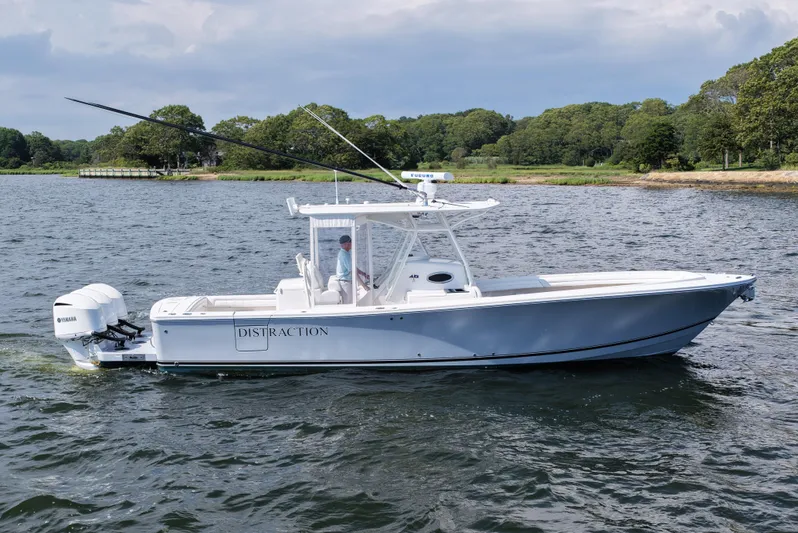 Distraction Yacht Photos Pics 2019 Regulator 34SS boat on water, featuring dual Yamaha engines and sleek design.