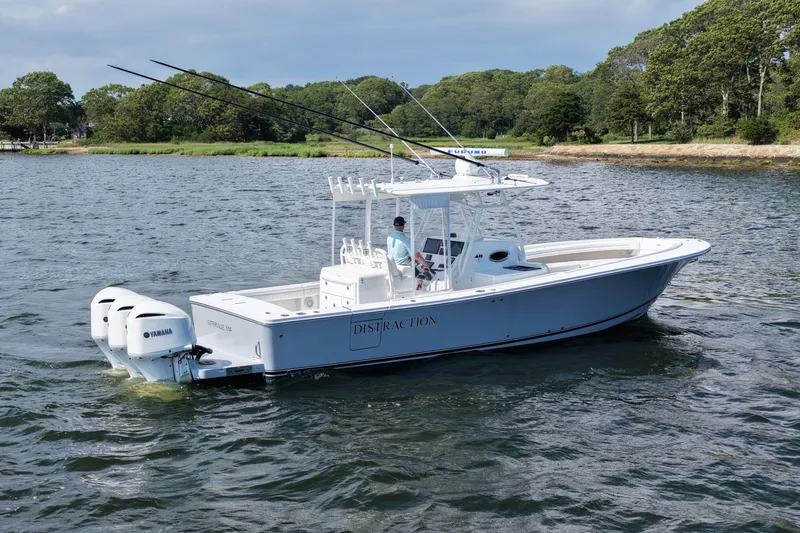 Distraction Yacht Photos Pics 2019 Regulator 34SS boat on water with Yamaha engines, surrounded by greenery.