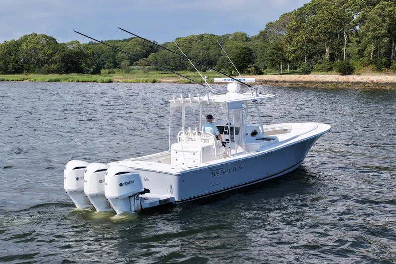 Distraction Yacht Photos Pics 2019 Regulator 34SS boat with triple Yamaha engines on a scenic waterway.