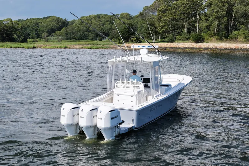 Distraction Yacht Photos Pics 2019 Regulator 34SS boat with triple Yamaha engines on a scenic waterway.