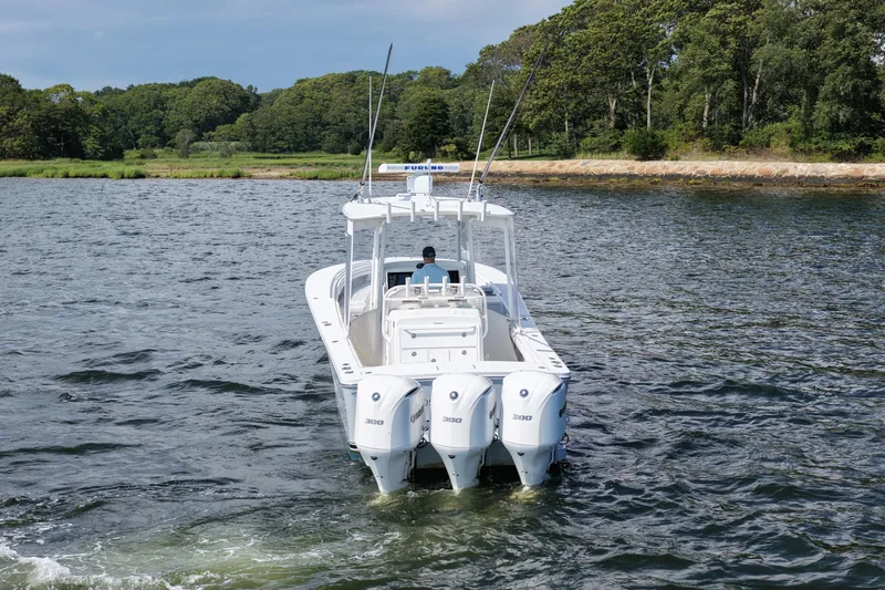 Distraction Yacht Photos Pics 2019 Regulator 34SS boat with triple engines on a scenic waterway.