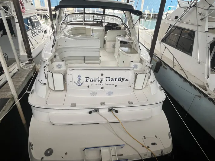  Yacht Photos Pics 2004 Regal Commodore 4260 yacht docked, featuring spacious seating and "Party Hardy" signage.