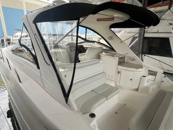  Yacht Photos Pics 2004 Regal Commodore 4260 yacht interior with seating and helm, docked in marina.