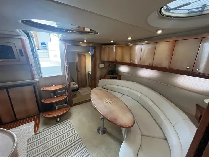  Yacht Photos Pics Luxurious interior of 2004 Regal Commodore 4260 yacht with elegant seating and wooden accents.