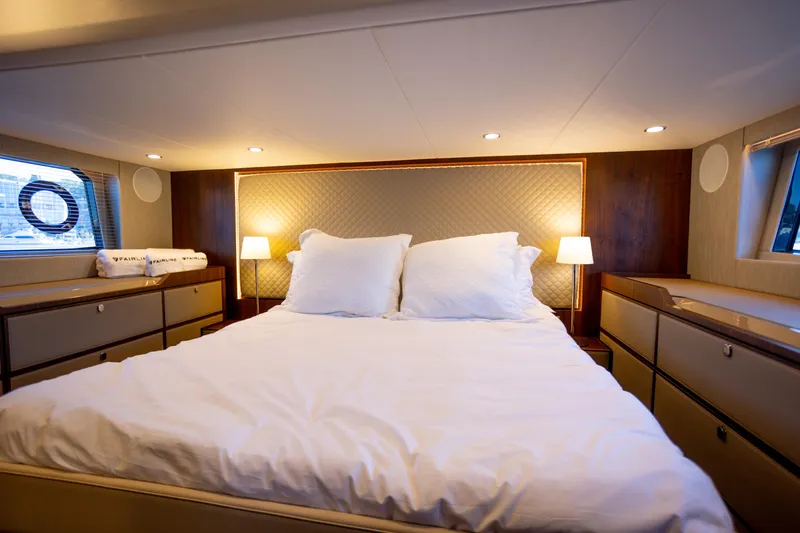 50 Fairline Yacht Photos Pics Luxurious bedroom interior of 2025 Fairline Squadron 50 yacht with elegant lighting and decor.