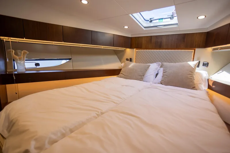 50 Fairline Yacht Photos Pics Luxurious bedroom interior of 2025 Fairline Squadron 50 yacht with elegant bedding and modern design.