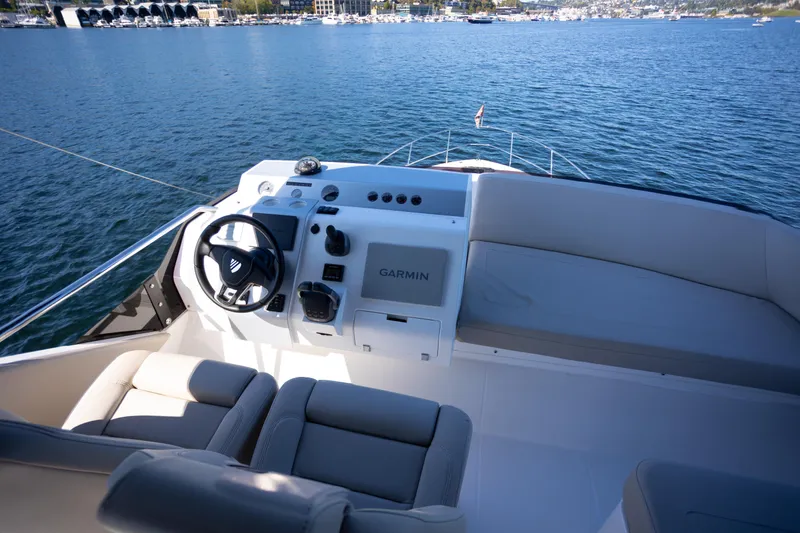 50 Fairline Yacht Photos Pics 2025 Fairline Squadron 50 yacht helm with Garmin navigation, overlooking serene waters.