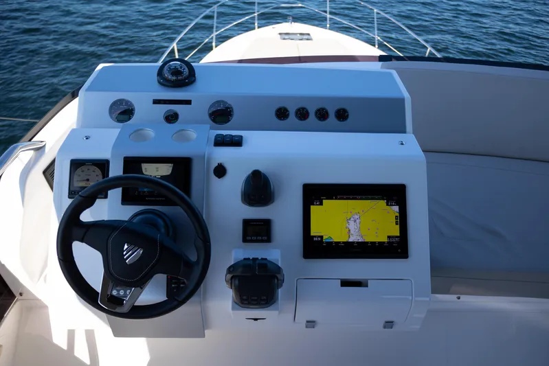 50 Fairline Yacht Photos Pics 2025 Fairline Squadron 50 yacht helm with navigation display and steering wheel.