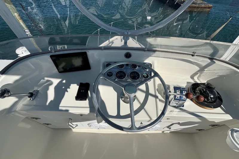 Bandit Yacht Photos Pics Helm of 1970 Bertram 31 Flybridge Cruiser with steering wheel and navigation instruments.