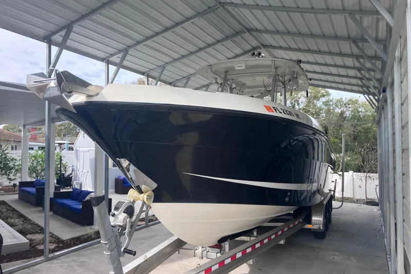  Yacht Photos Pics 2008 Hydra-Sports Vector 2900 CC boat under a metal shelter on a trailer.