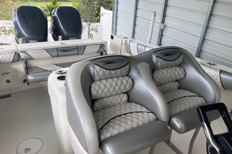  Yacht Photos Pics 2008 Hydra-Sports Vector 2900 CC boat interior with cushioned seating and dual engines.