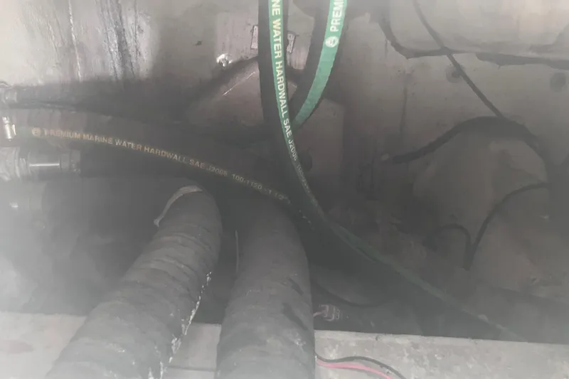  Yacht Photos Pics 2008 Hydra-Sports Vector 2900 CC engine compartment with marine water hoses visible.