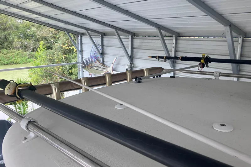  Yacht Photos Pics 2008 Hydra-Sports Vector 2900 CC boat under metal shelter with fishing rods.