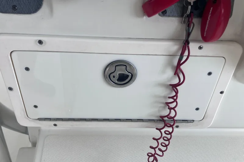  Yacht Photos Pics 2008 Hydra-Sports Vector 2900 CC boat compartment with red safety lanyard and key.