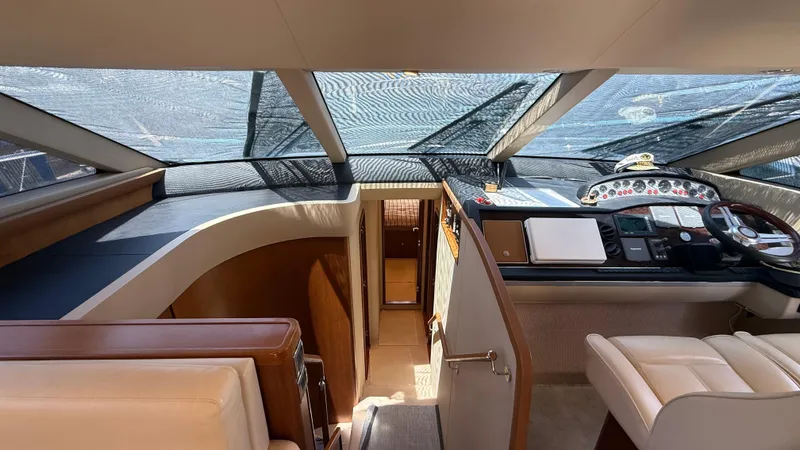  Yacht Photos Pics Interior of 2010 Princess 62 yacht, featuring helm station and luxurious seating.