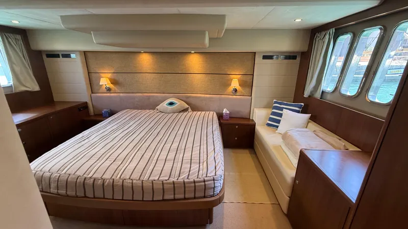  Yacht Photos Pics Luxurious bedroom interior of 2010 Princess 62 yacht with elegant furnishings and large windows.