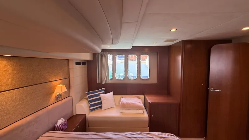  Yacht Photos Pics Luxurious cabin interior of a 2010 Princess 62 yacht with cozy seating and elegant decor.