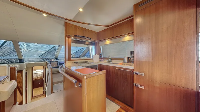  Yacht Photos Pics Luxurious interior of 2010 Princess 62 yacht with modern kitchen and wood finishes.