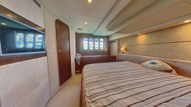  Yacht Photos Pics Luxurious bedroom interior of 2010 Princess 62 yacht with striped bedding and elegant wood finishes.