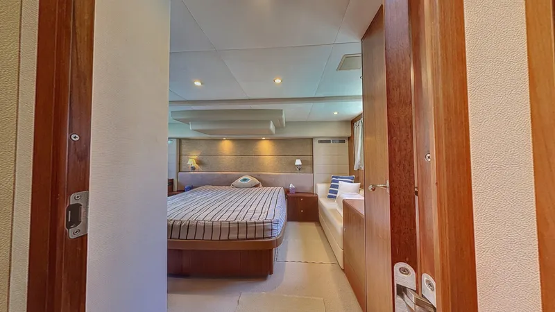  Yacht Photos Pics Luxurious bedroom interior of 2010 Princess 62 yacht with cozy bed and elegant decor.