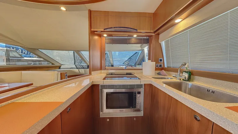  Yacht Photos Pics Luxurious kitchen interior of 2010 Princess 62 yacht with modern appliances and sleek design.