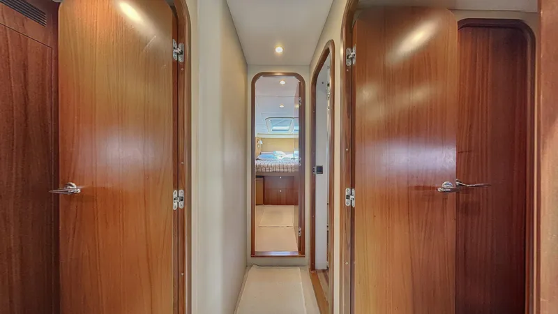  Yacht Photos Pics Hallway inside 2010 Princess 62 yacht with wooden doors and cozy lighting.