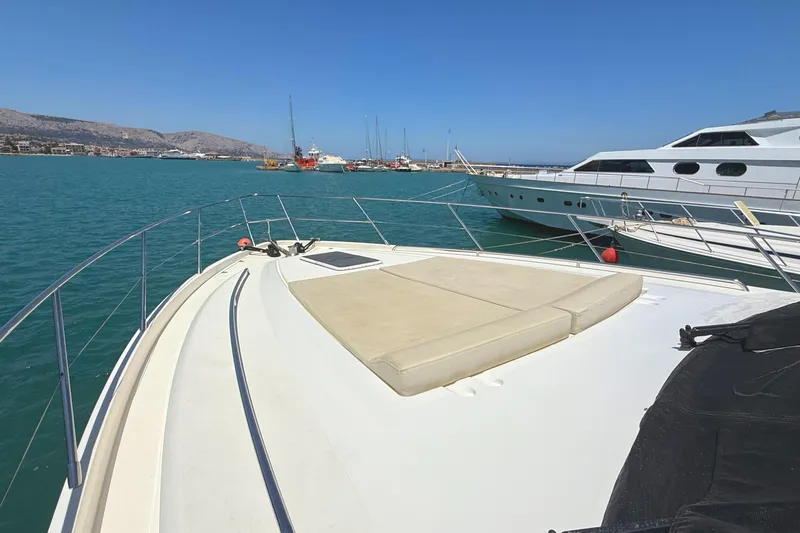  Yacht Photos Pics Luxurious 2010 Princess 62 yacht docked in a serene marina setting.