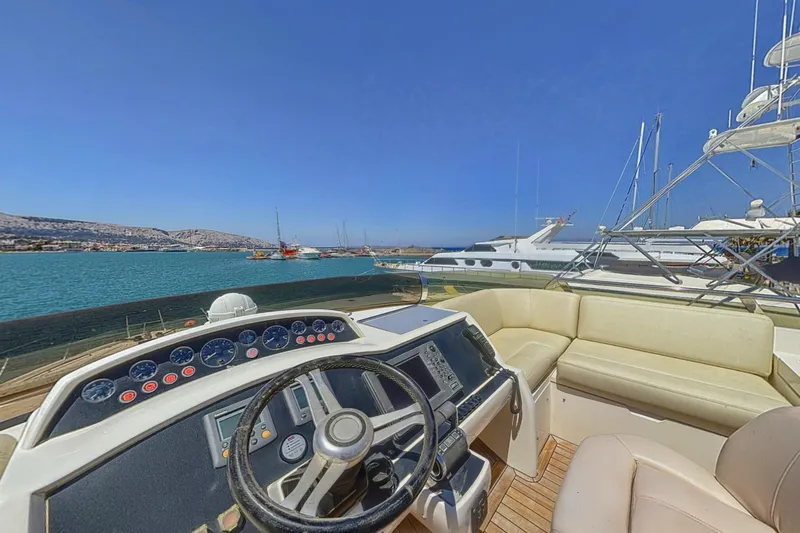  Yacht Photos Pics Helm of 2010 Princess 62 yacht with ocean view and docked boats.