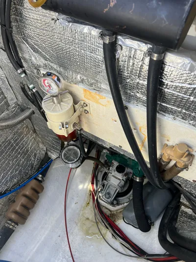 Taco Truck Yacht Photos Pics Engine compartment of a 1996 Prout 45 catamaran with visible hoses and components.