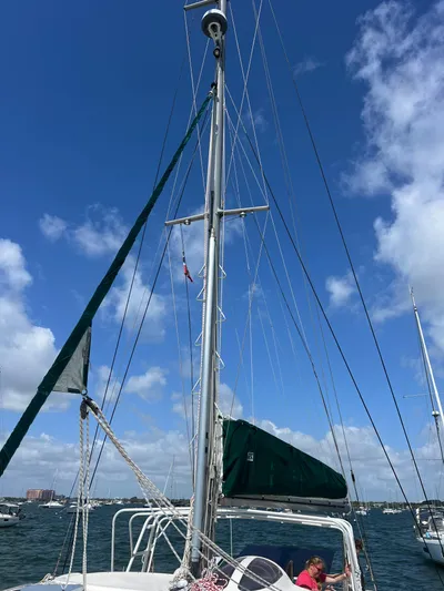 Taco Truck Yacht Photos Pics Sailboat Prout 45, 1996 model, with tall mast against blue sky and clouds.