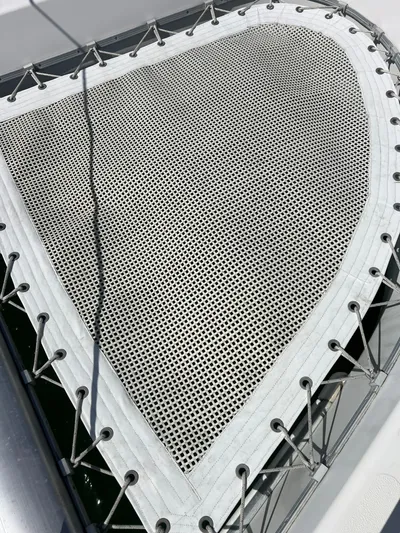 Taco Truck Yacht Photos Pics Trampoline netting on a 1996 Prout 45 catamaran, secured with ropes.
