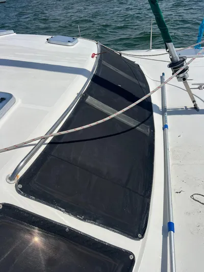 Taco Truck Yacht Photos Pics 1996 Prout 45 sailboat deck with netting and rigging, on calm water.