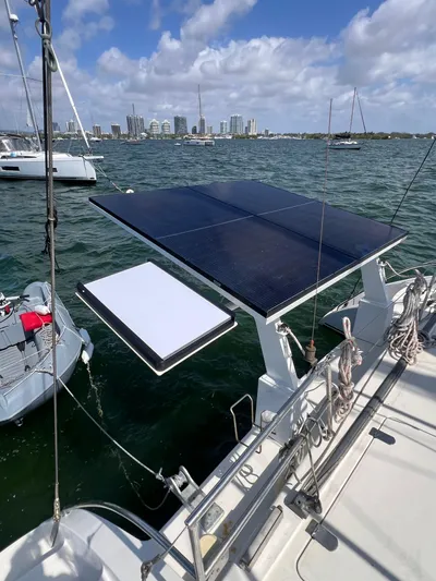 Taco Truck Yacht Photos Pics Sailboat with solar panels on deck, Prout 45, 1996, anchored near city skyline.