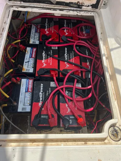 Taco Truck Yacht Photos Pics Battery compartment of a 1996 Prout 45 boat, featuring multiple red batteries and wiring.