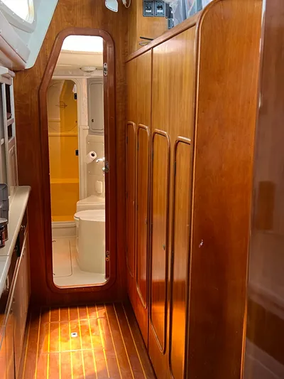 Taco Truck Yacht Photos Pics Interior of 1996 Prout 45 yacht with wooden cabinetry and visible bathroom.