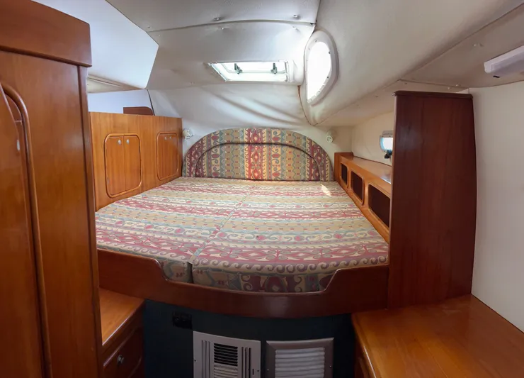 Taco Truck Yacht Photos Pics Cozy cabin interior of 1996 Prout 45 yacht with patterned bedding and wooden furnishings.