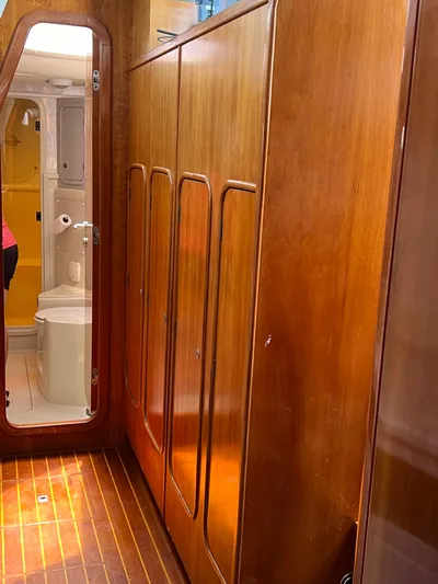 Taco Truck Yacht Photos Pics Interior of 1996 Prout 45 yacht with wooden cabinets and bathroom view.